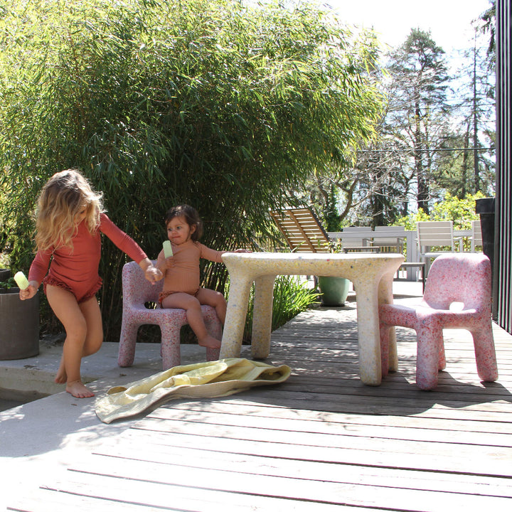 Toddler and child eating and playing around ecoBirdy outdoor furniture set Sunrise